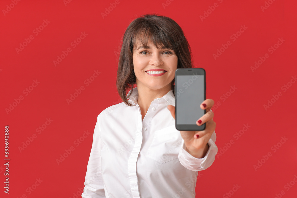 Beautiful mature woman with mobile phone on color background Beautiful mature woman with mobile phone on color background