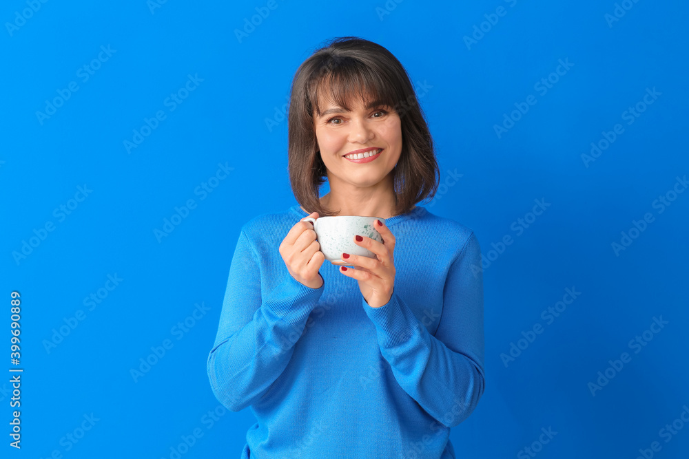 Beautiful mature woman with cup of tea on color background Beautiful mature woman with cup of tea on color background