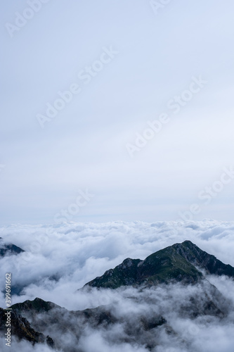 Dramatic view of Kiso Mountains engulfed in a sea of clouds in early autumn at Senjojiki Cirque in Nagano Prefecture  Japan.