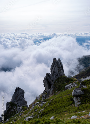 Rock formations in grassy mountains above the clouds in early autumn at Mount Kisokoma in Nagano Prefecture, Japan. photo