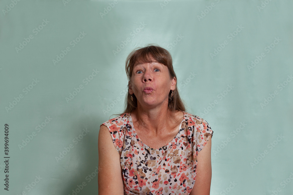 Middle aged woman making a kissing face.