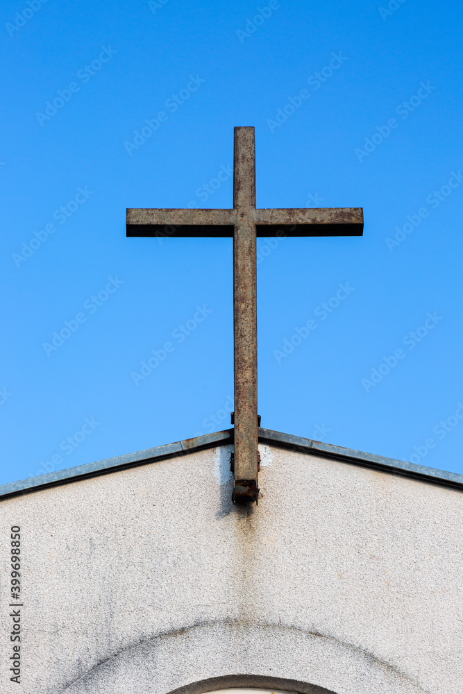 Old rusty metal cross in church