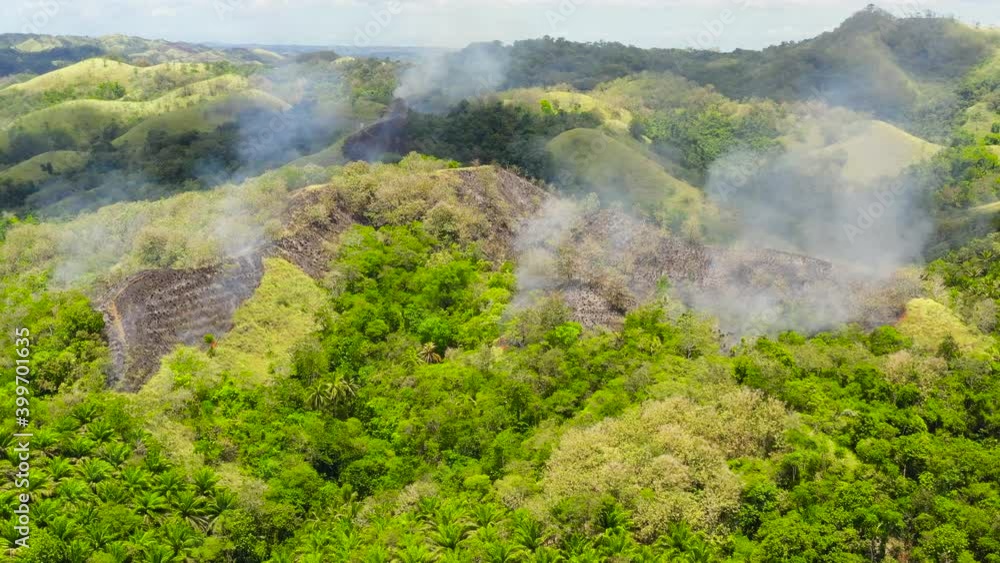 Forest fire in the mountains. Using fire to destroy natural habitat and causing large scale environmental damage in Asia. Bohol,Philippines. Forest fire in the mountains. Using fire to destroy natural habitat and causing large scale environmental damage in Asia. Bohol,Philippines.
