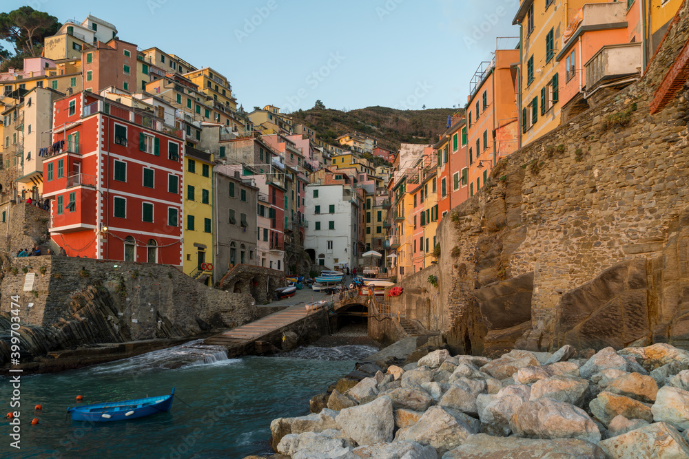 Riomaggiore at a sunset. It is one of colorful villages of Cinque Terre in Italy, suspended between sea and land
