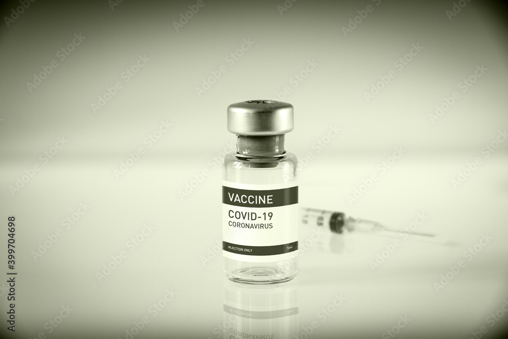 Covid-19 vaccine bottle and syringe on a black and white background ...
