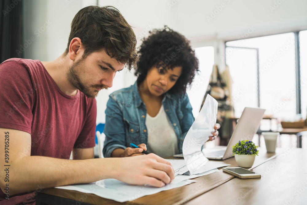 Creative designers working in a project together. Creative designers working in a project together.