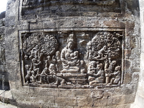 Stone carving on the wall of Mendut Temple, Central Java, Indonesia photo