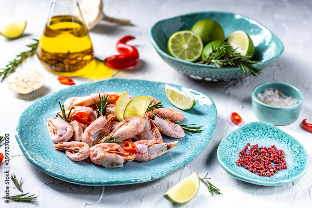 Boiled shrimp served with lime, rosemary, chili on a blue plate, Seafood Boiled shrimp served with lime, rosemary, chili on a blue plate, Seafood