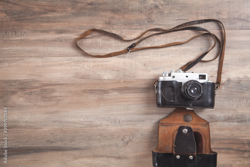 Old retro camera on wooden background. Old retro camera on wooden background.