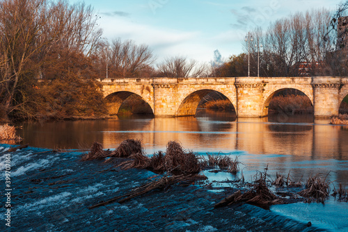 ashlar stone medieval bridge, puente mayor, crossing rio carrion, in autumn