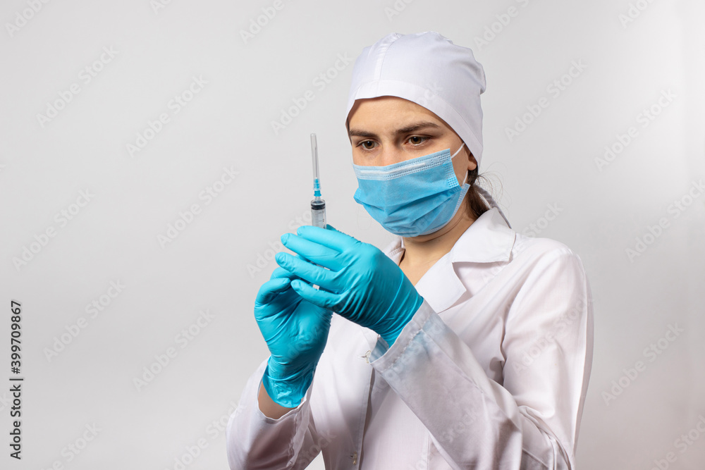 The doctor holds a syringe with a vaccine to vaccinate against coronavirus, tuberculosis, diphtheria and rabies. Treatment and prevention of diseases. Nurse and injection The doctor holds a syringe with a vaccine to vaccinate against coronavirus, tuberculosis, diphtheria and rabies. Treatment and prevention of diseases. Nurse and injection