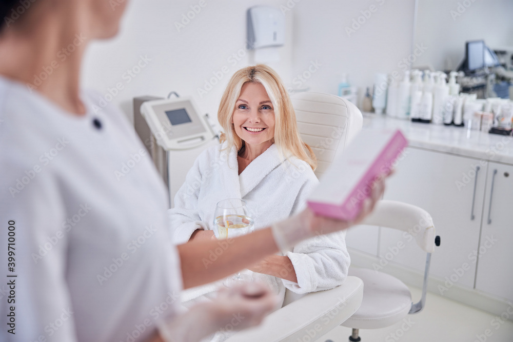 Pretty lady in white clothes looking to her doctor in cabinet Pretty lady in white clothes looking to her doctor in cabinet