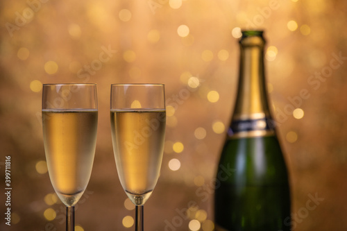 Champagne glasses over holiday bokeh blinking background, rotating on turntable, glasses with sparkling wine, celebration, party. High quality 4k footage
