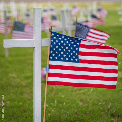 USA Flag with a cross in cemetery