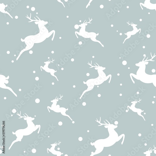 seamless winter pattern with white snowflakes and deers with antlers. © Ne Mariya