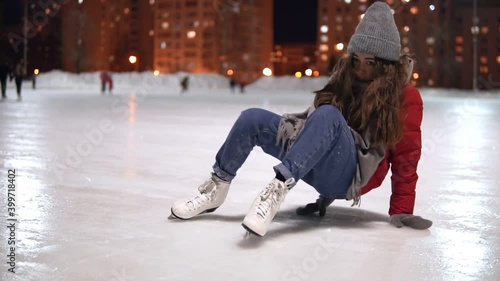 Beautiful woman fell while ice skating and hit her knee.