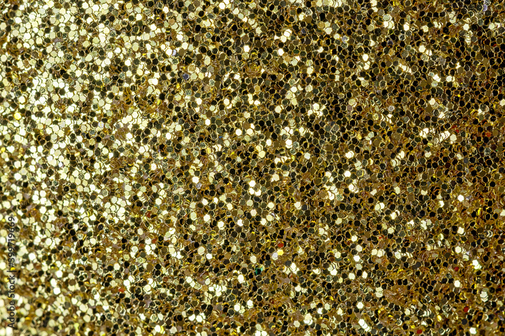 Shiny background for layouts and websites. Gold sequins close up.