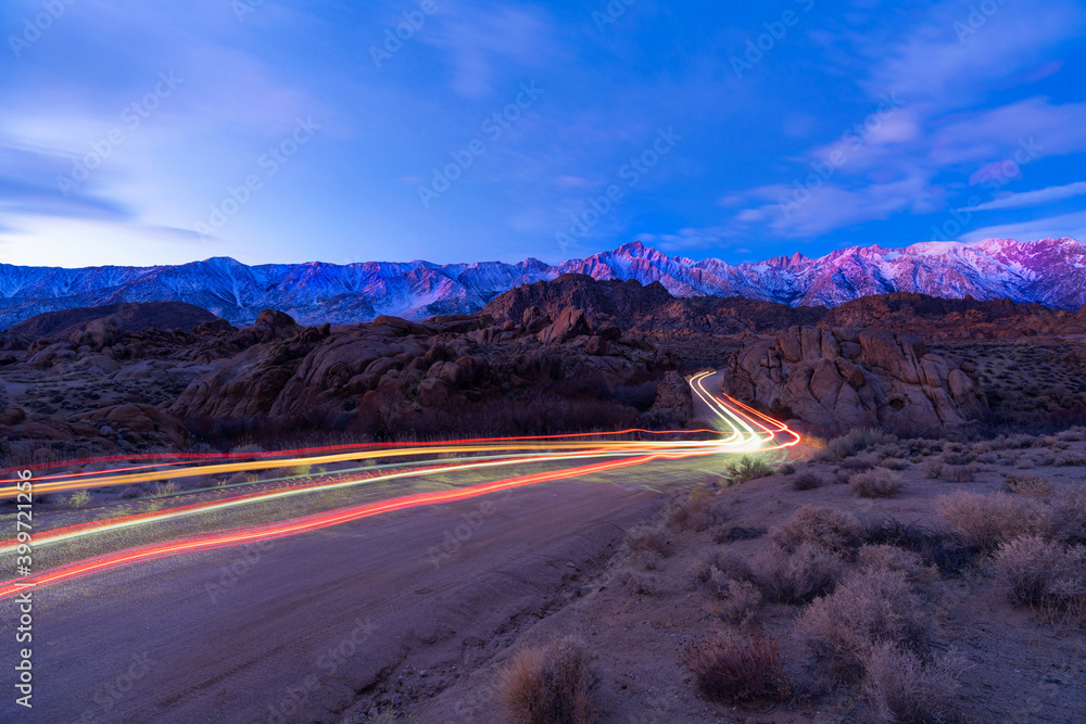 Sierra Nevada Mountains covered by snow and clouds, California, USA with light trail. Sierra Nevada Mountains covered by snow and clouds, California, USA with light trail.