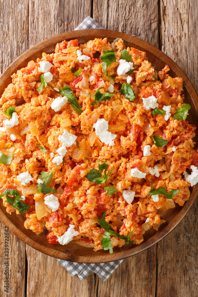 Greek tomato scrambled eggs Strapatsada closeup in the plate on the table. vertical top view from above Greek tomato scrambled eggs Strapatsada closeup in the plate on the table. vertical top view from above