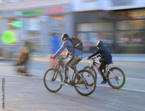 Cyclists on the city roadway in motion blur. Intentional motion blur