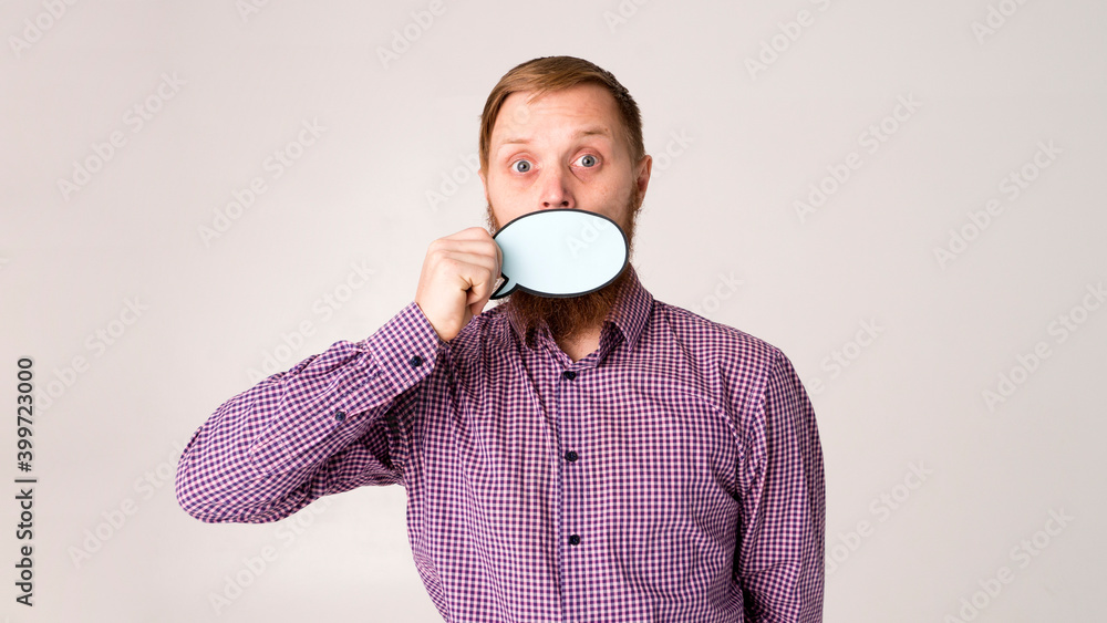 Attractive young man is holding a speech bubble Attractive young man is holding a speech bubble