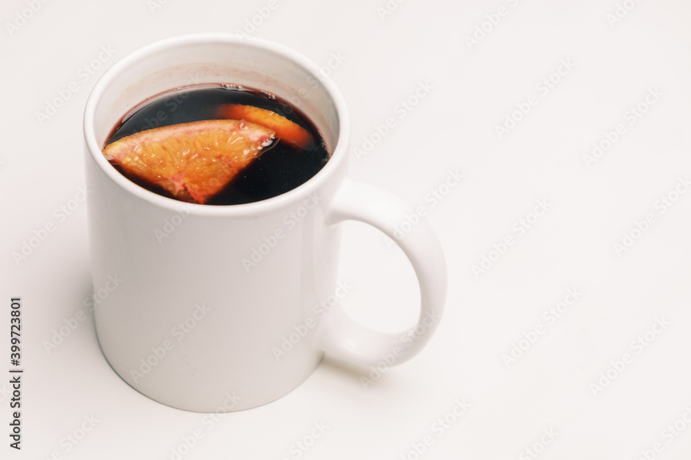Mug with mulled hot wine with orange on the white background. Mug with mulled hot wine with orange on the white background.