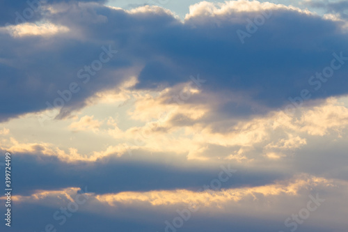 cloudy sky in yellow light. natural background at sunrise. inspiring scene