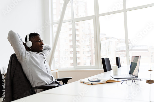 Attractive young dark-skinned businessman in office