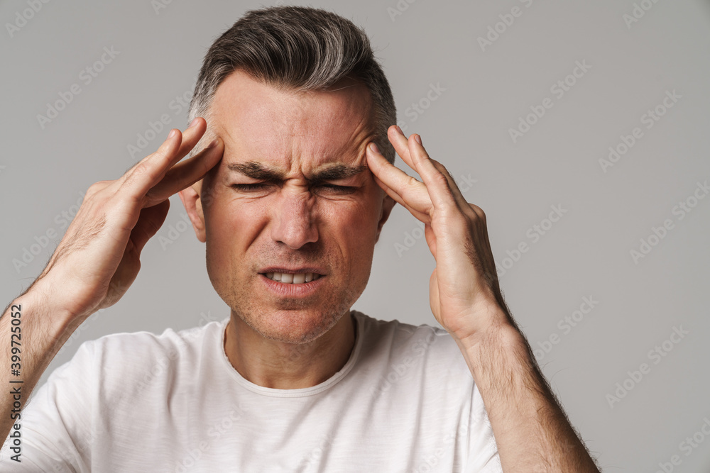 Worried man suffering from headache isolated Worried man suffering from headache isolated