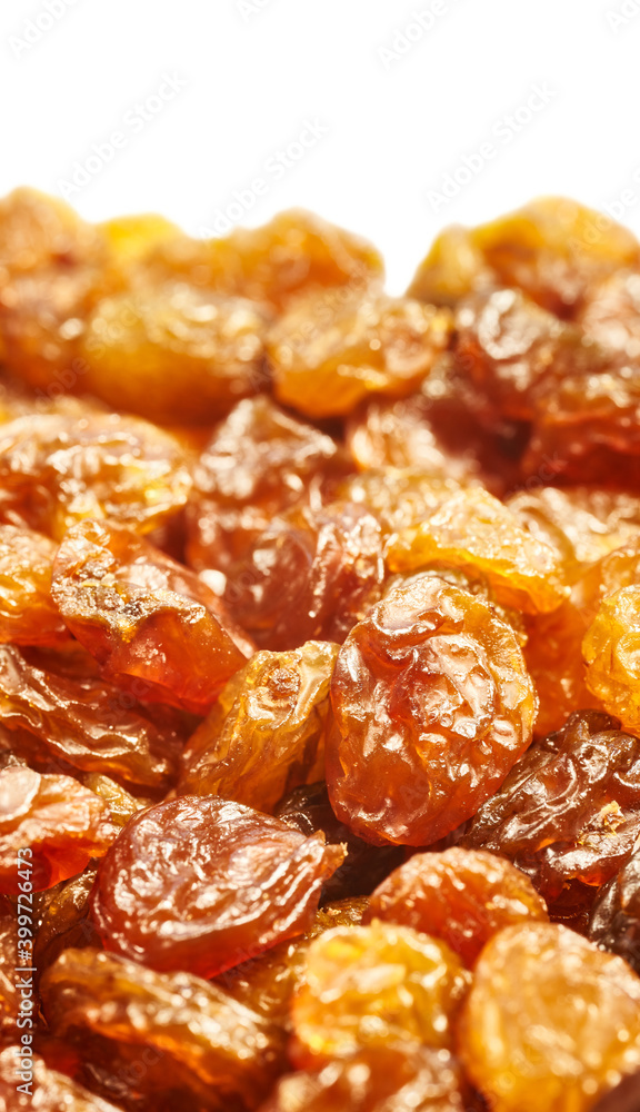 Close up of golden sultana raisins on white background, selective focus. Close up of golden sultana raisins on white background, selective focus.