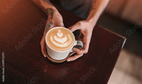 Barista serving coffee with latte art