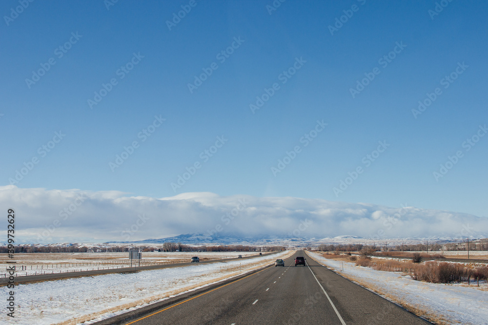 Highway in the middle of the mountains in a snowy winter. A beautiful asphalt road among the snow-covered mountains. Utah, USA Highway in the middle of the mountains in a snowy winter. A beautiful asphalt road among the snow-covered mountains. Utah, USA