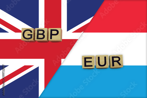 United Kingdom and Luxembourg currencies codes on national flags background © andreyakaan147