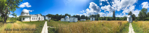 photo panoramic view of the pavilions with telescopes on the meadow in the Engelhardt Astronomical Observatory, an architectural monument and a museum, Kazan, Russia