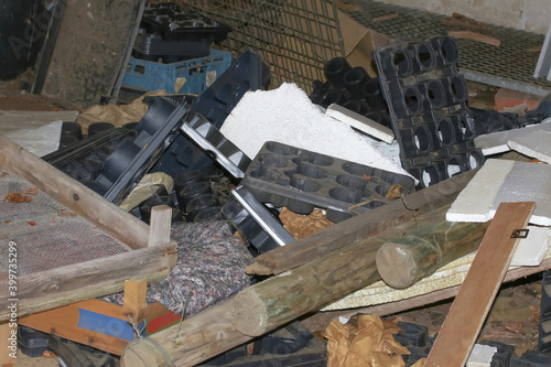 Müllhaufen mit Pflanzkästen, Holzpfosten und Kunststoff