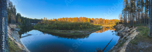 Fototapeta Naklejka Na Ścianę i Meble -  photo, background, panoramic view of the bend of the Kokshaga river in the reserved Mari forest, among coniferous and deciduous trees, Volga region, Russia
