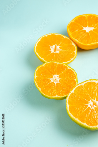 front view fresh tangerine slices lined on light-blue background color orange photo juice fruit citrus