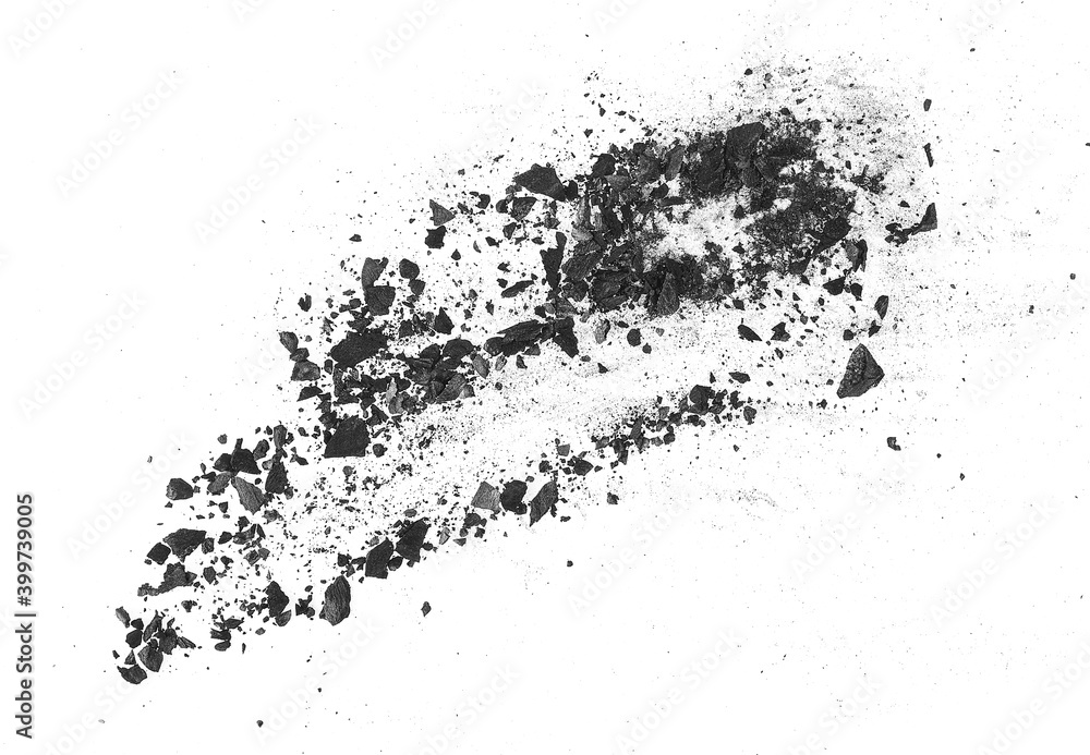 Fototapeta premium Black charcoal particles isolated on a white background, top view. Activated charcoal powder for facial mask. Black dust powder charcoal.