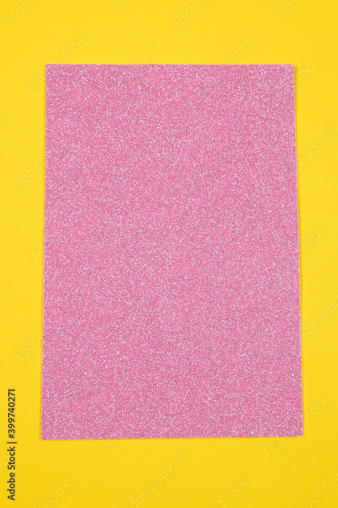 Fototapeta premium Mockup, pink shiny sheet over yellow background. Holiday, festive backdrop.