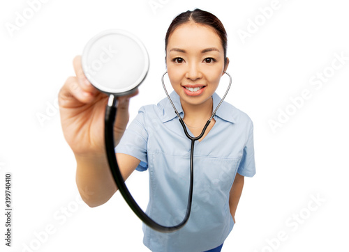 medicine, profession and healthcare concept - portrait of happy smiling asian female doctor or nurse in blue uniform with stethoscope over white background © Syda Productions