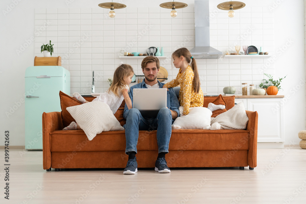 Father working from home with children. Homeschooling, stay home, social distancing during coronavirus quarantine Father working from home with children. Homeschooling, stay home, social distancing during coronavirus quarantine