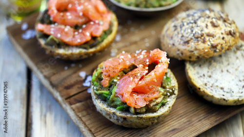 Salmon avocado sandwiches on buns with seeds. The keto diet. Healthy breakfast or snack.