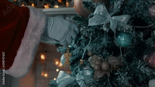 Christmas toy. Santa's hand hangs a toy.