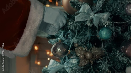 Ball toy. Santa's hand hangs a toy. Ball on Christmas tree.