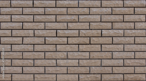 Brick beige with gnawed and chipped surfaces texture. Tiling clean for background pattern.