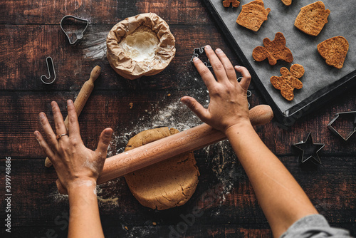 Making gingerbread christmas cookies on wooden background