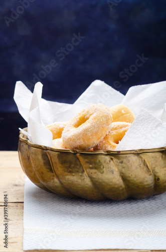 Traditional Carnival Italian fritters dusted sugar with honey and sprinkles. photo