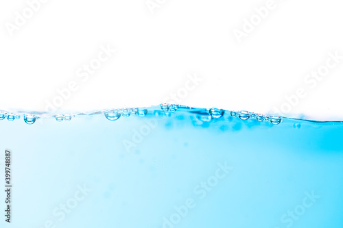 Wavy motion on surface of water and bubbles created by the movement.