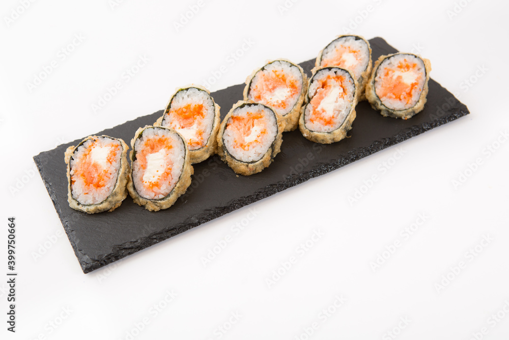 Japanese seafood sushi, roll on shale food board on white background Japanese seafood sushi, roll on shale food board on white background