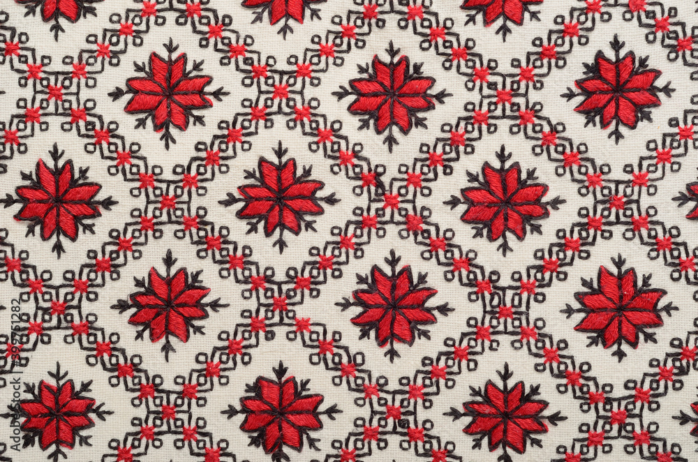 Embroidered with red threads canvas with home-woven fabric background Embroidered with red threads canvas with home-woven fabric background